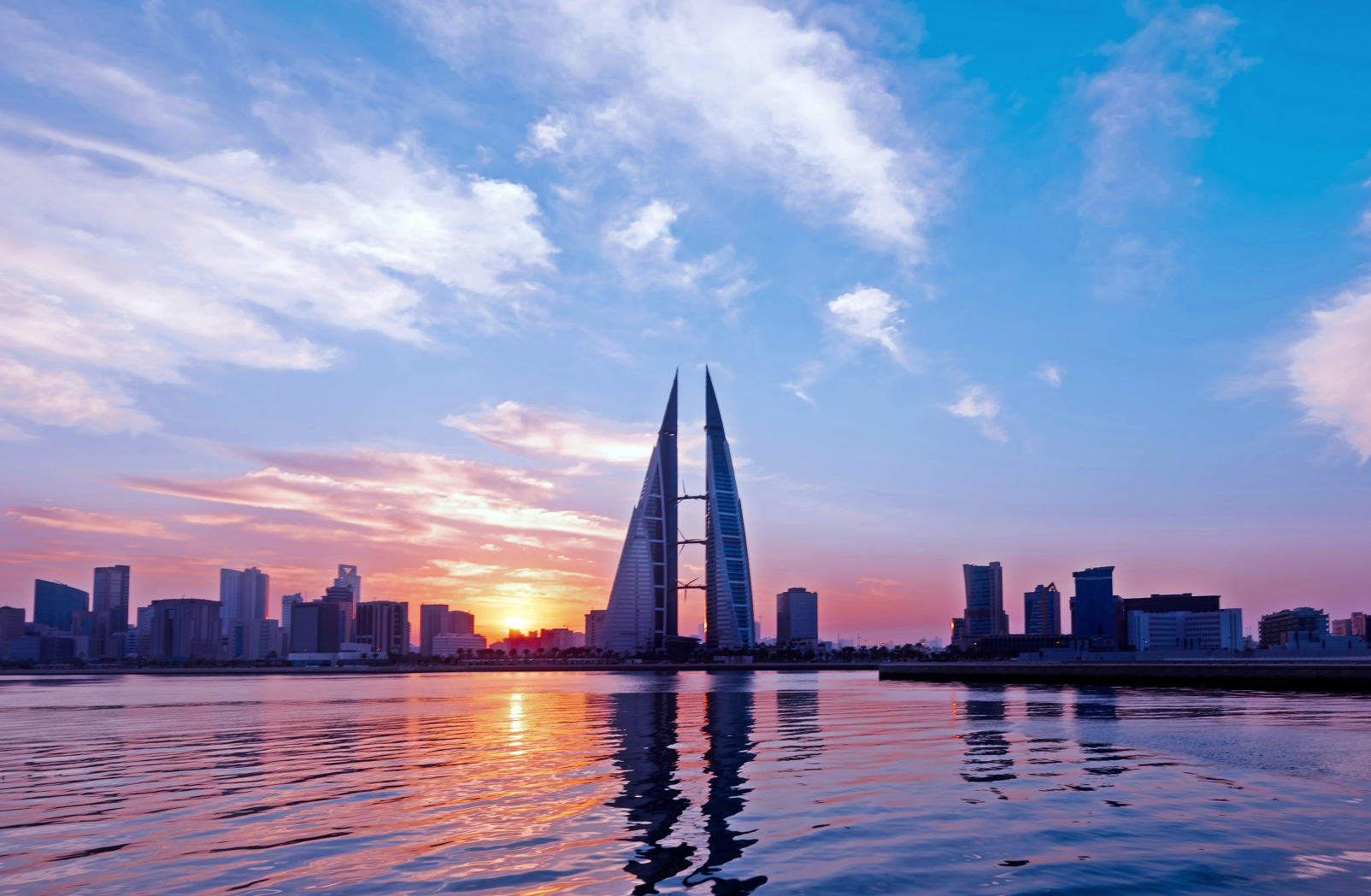 View of the Bahrain Harbour Tower, a prominent landmark in Bahrain, reflecting the architectural modernity and cultural significance of the region. The image showcases the iconic structure surrounded by other well-known places in Bahrain, symbolizing the country's growth and heritage.